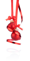 Two Red Christmas ball hanging with ribbon bow and curling paper