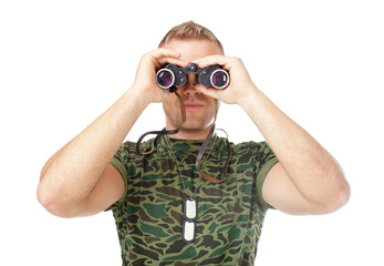 Young army soldier looking through binoculars