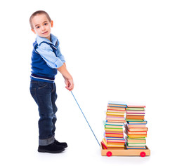 Little boy pulling books in toy cart