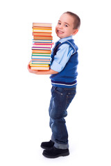 Little boy carrying stacked books