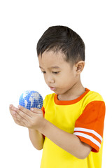 Asian boy holding our planet earth in his hand.