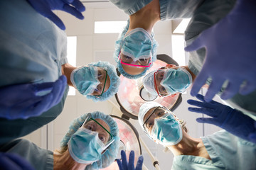 Multiethnic Medical Team With Masks And Scrubs In Operation Room