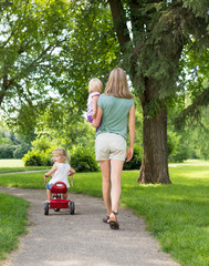 Woman With Children Strolling In Park