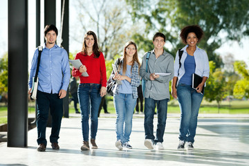 Confident Students Walking In A Row On Campus
