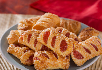 Strawberry and apple filled sugar coated puff pastry cakes close - obrazy, fototapety, plakaty