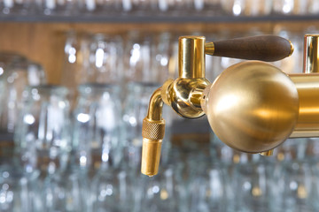 beer tap detail with handle amde from gold metal - obrazy, fototapety, plakaty