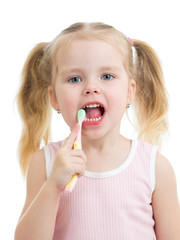 kid girl brushing teeth isolated on white