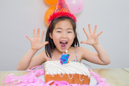 Cheerful little girl at her birthday party
