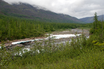 The ice-field in the tideway of the mountain river.