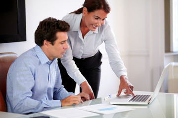Beautiful hispanic secretary helping her boss