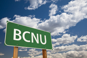 BCNU Green Road Sign Over Sky