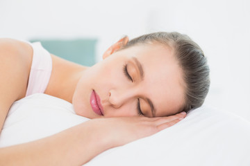 Obraz na płótnie Canvas Pretty woman sleeping with eyes closed in bed