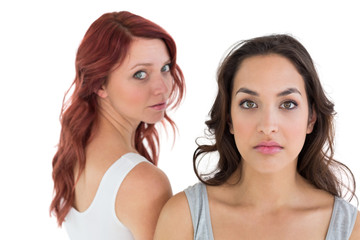 Unhappy young female friends not talking after argument