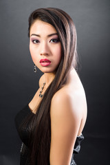 Fototapeta premium Beautiful brunette Asian woman with long black hair
