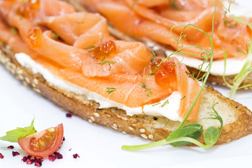 sandwiches with salmon caviar and greens adorned