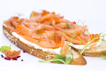 sandwiches with salmon caviar and greens adorned