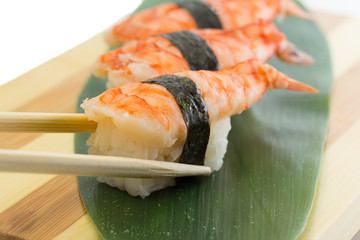 Shrimp sushi nigiri on wooden plate