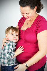 Pregnant woman hugging little boy