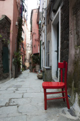 Obraz na płótnie Canvas Red Chair in Italian alley