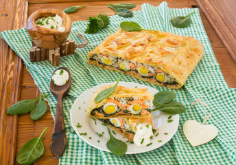 Pie with salmon, spinach, rice, and eggs