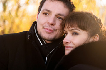 Fototapeta premium Young couple looks forward on the yellow leaves
