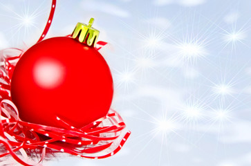 Red christmas ball on shining snow background