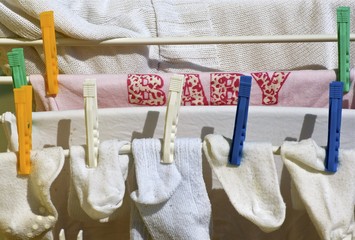 Washed baby clothes hanging on clotheslines.