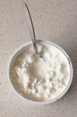 Cottage cheese and teaspoon. Diet and healthy nutrition.