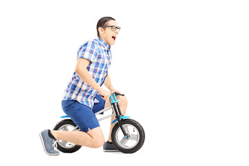 Excited guy riding a small bicycle