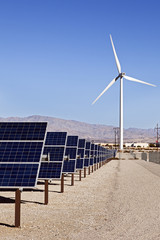 A View of Solar Panels and Wind Turbine in the Field