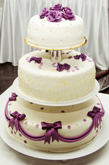 White wedding cake with purple flower detail