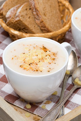 Delicious cream soup of cauliflower with cheese, close-up