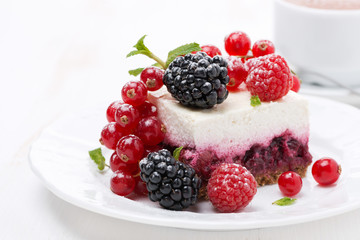 piece of cheesecake with fresh berries and coffee