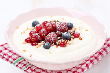semolina porridge with berries and nuts, close-up
