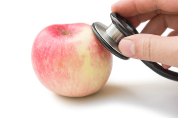 hearing an apple with stethoscope with clipping path