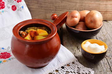 Potatoes with meat in a ceramic pot