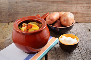 Potatoes with meat in a ceramic pot