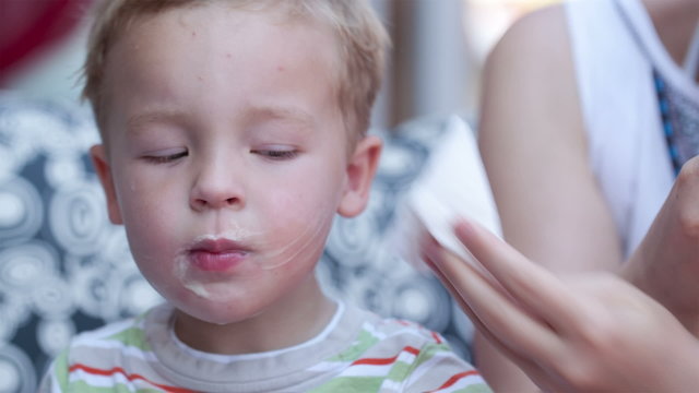 Cute little boy eating an ice cream cone