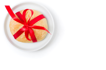 Homemade bread roll with red bow jumpered on the plate