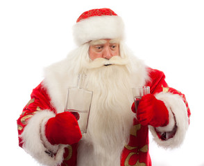 Obraz na płótnie Canvas Santa Claus is pouring vodka into the glass.