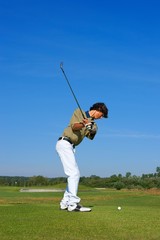 Golf, golfer striking the ball