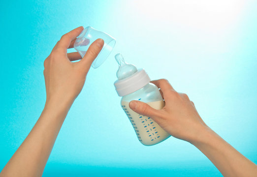 Small bottle with milk in female hands