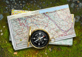 Compass and map on moss