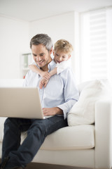 father and son playing on a computer