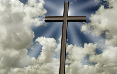 Cross in front of a partly cloudy sky