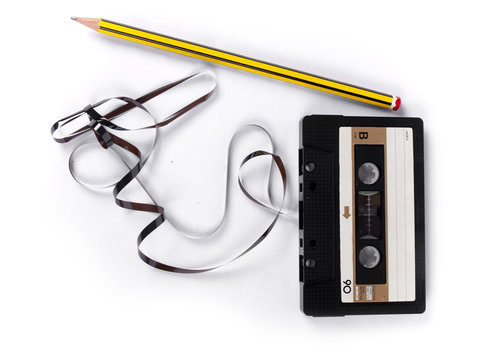 retro cassette with loose tape over a white background