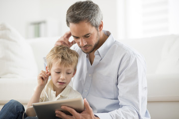 father and son sharing music headphones