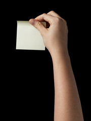 female teen hand holding sticky note