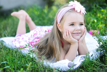 pretty little girl on green grass