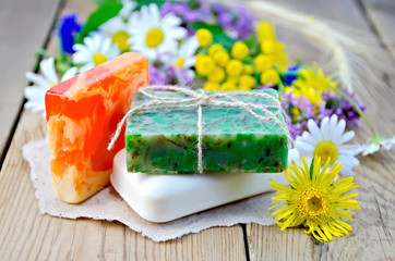 Soap homemade with wildflowers on the board
